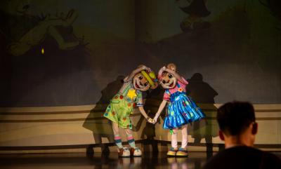 A picture with children characters on a stage