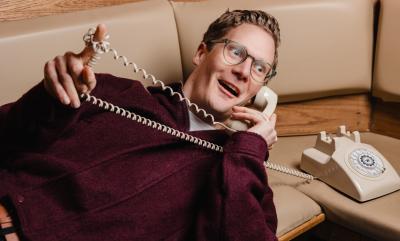 A man on a phone looking shocked