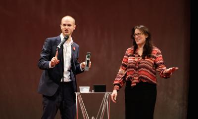 A man holding something and a woman with her hand out